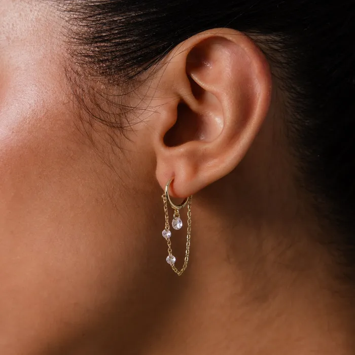 Crystal Chain Drop Huggies worn on an ear