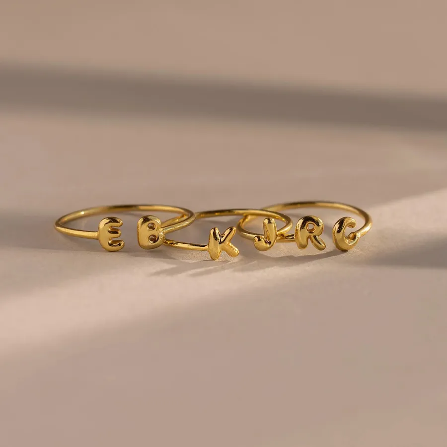 The Duo Bubble Initial Ring in gold showing the letters E, K, and R