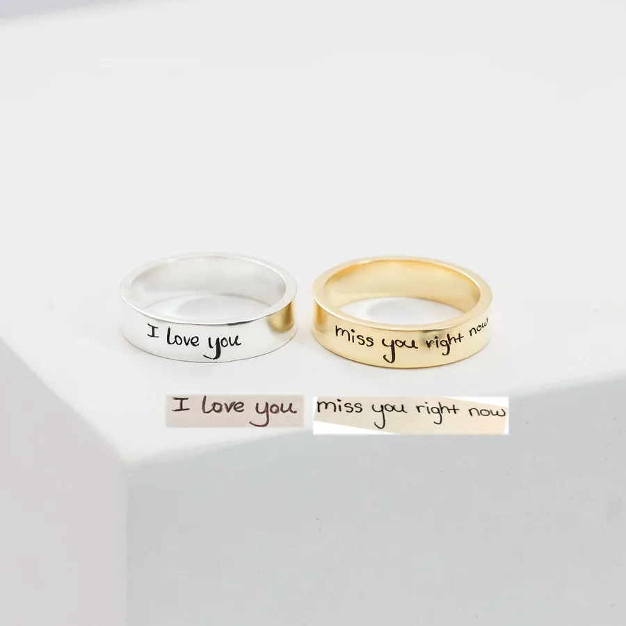 A silver Handwriting Band and a gold custom ring, each engraved in handwriting