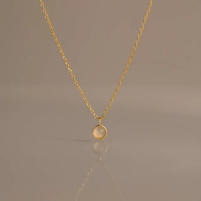 Moonstone Charm Necklace, a round moonstone pendant on a gold chain