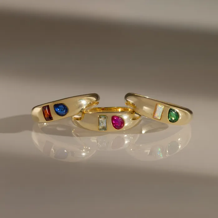Three gold Toi et Moi Dome Rings with paired colored stones