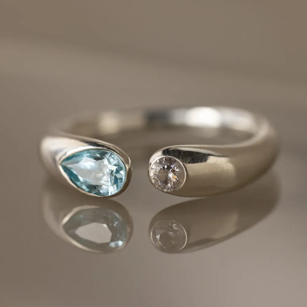 Silver Toi et Moi Birthstone Signet Ring with a pear cut blue stone and a round clear stone